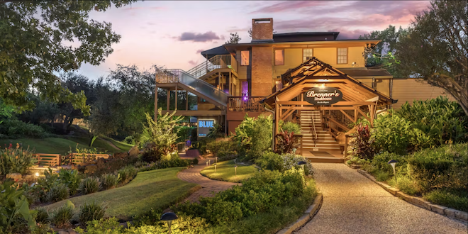 The exterior of the Brenner's on the Bayou is surrounded by greenery. 